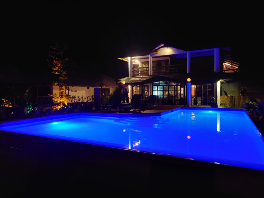 Nighttime view of the pool and Kitchen at Romantic Beach Villas, General Luna, Siargao, Philippines