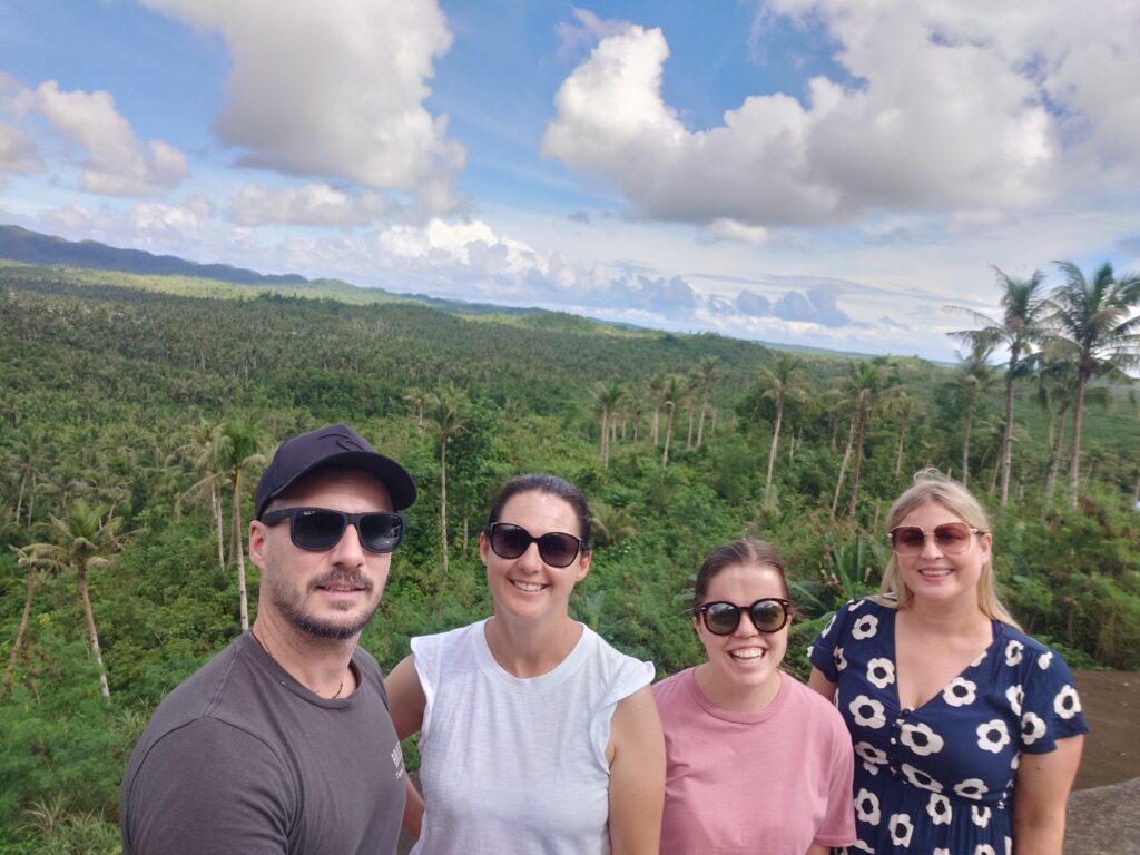 Rhys Alexander Sain, Rhiana Ravindran, Taylor Shepherd, Lauren Higgins taking a selfie at A view from the coconut viewdeck in Siargao, Philippines