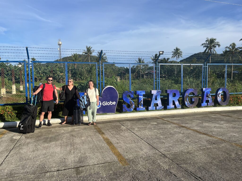 Rhys Alexander Sain, Lauren Higggins, Taylor Shepherd outside Siargao Airport