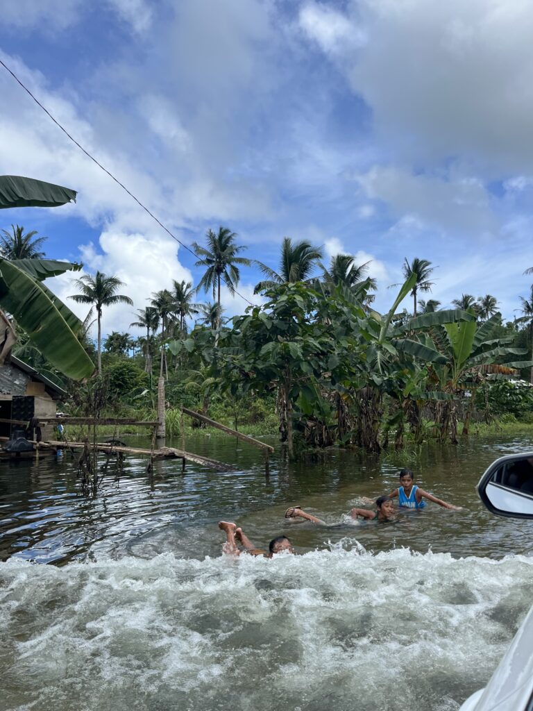 Kids playing in the flooded streets in Siargao, Philippines