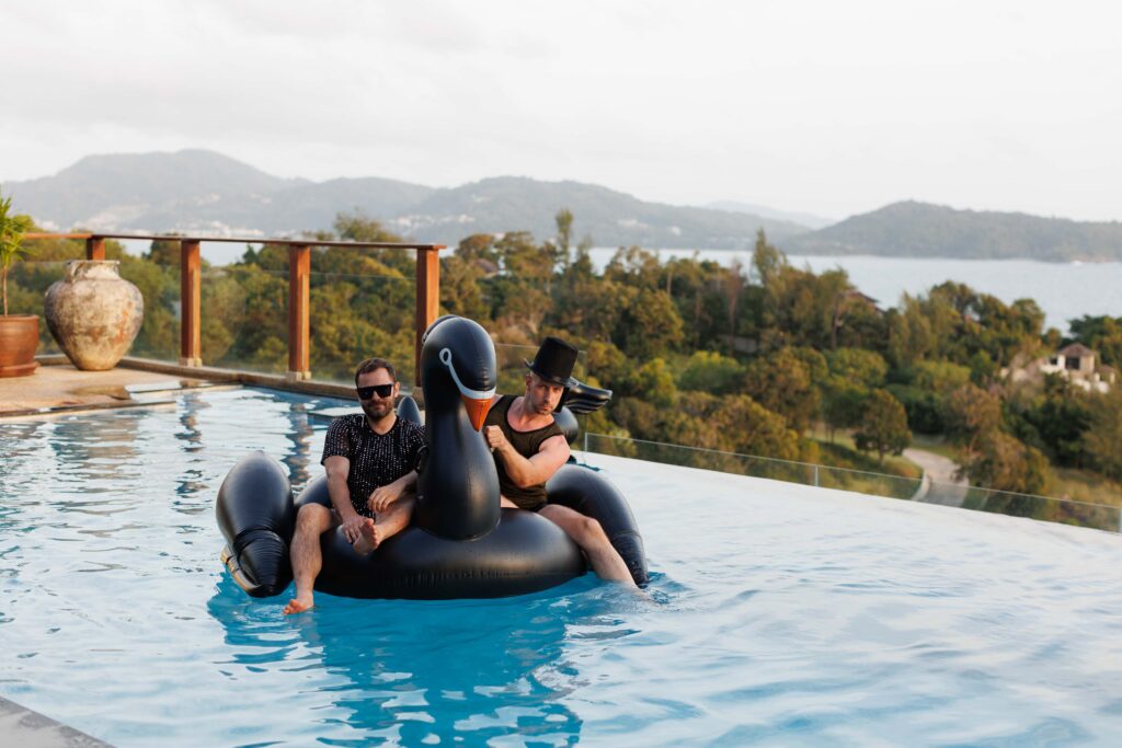 Steven Jarczyk and John Benzinger on the inflatable swan in Villa Aye's infinity pool, Kamala, Phuket, Thailand